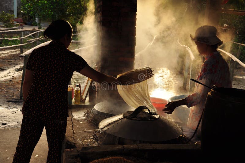 Vietnamese cuisine. Women cooking rice paste dough to make rice noodle, Vietnam. Vietnamese cuisine. Women cooking rice paste dough to make rice noodle, Vietnam