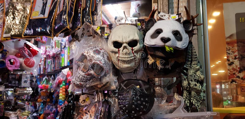 Scary masks and other plastic colorful stuff for children exposed for sale in a shop before jewish purim masquerade