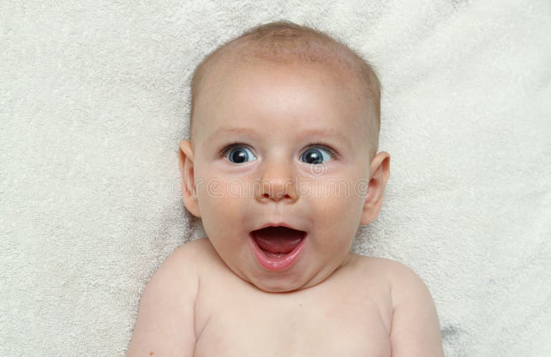 Riso aberto de sorriso entusiasmado adorável da boca do bebê