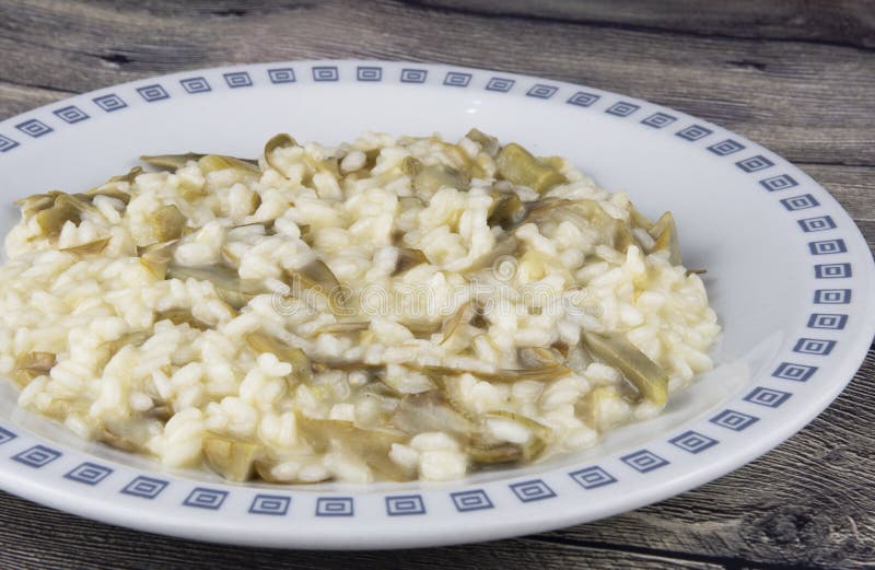 This is a basic risotto bianco with very thinly sliced artichokes added to it, which give it a wonderful perfume. You need small artichokes for this dish – not the large globe ones. When things like artichokes or courgettes are sliced thinly the Italians call this trifolati, which literally translates as ‘in the style of truffles’, i.e. wafer thin. This is a basic risotto bianco with very thinly sliced artichokes added to it, which give it a wonderful perfume. You need small artichokes for this dish – not the large globe ones. When things like artichokes or courgettes are sliced thinly the Italians call this trifolati, which literally translates as ‘in the style of truffles’, i.e. wafer thin.