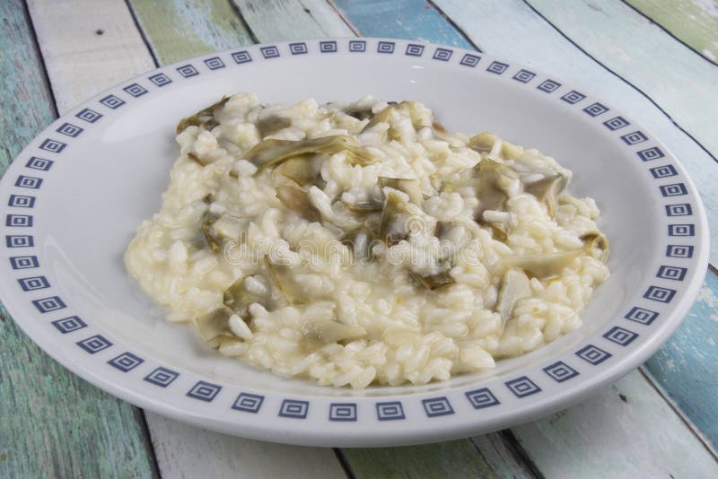 This is a basic risotto bianco with very thinly sliced artichokes added to it, which give it a wonderful perfume. You need small artichokes for this dish – not the large globe ones. When things like artichokes or courgettes are sliced thinly the Italians call this trifolati, which literally translates as ‘in the style of truffles’, i.e. wafer thin. This is a basic risotto bianco with very thinly sliced artichokes added to it, which give it a wonderful perfume. You need small artichokes for this dish – not the large globe ones. When things like artichokes or courgettes are sliced thinly the Italians call this trifolati, which literally translates as ‘in the style of truffles’, i.e. wafer thin.