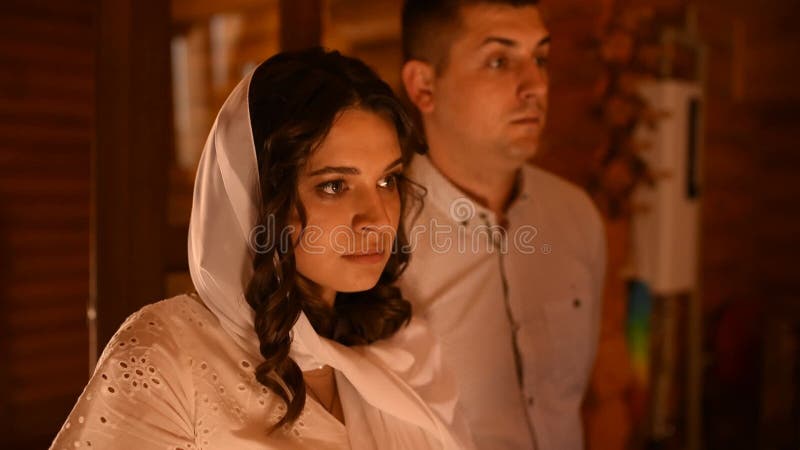 Rite of sacrament of epiphany child God-parents. woman in headscarf