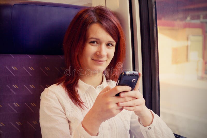Ritenere sorridente della giovane donna rilassato e parlare con viaggio del telefono cellulare fotografia stock Ritenere sorridente della giovane donna rilassato e parlare con viaggio del telefono cellulare fotografia stock