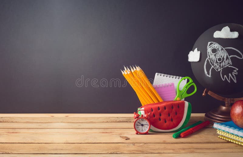 Back to school  creative background with watermelon pencil case and school supplies on wooden table. Back to school  creative background with watermelon pencil case and school supplies on wooden table