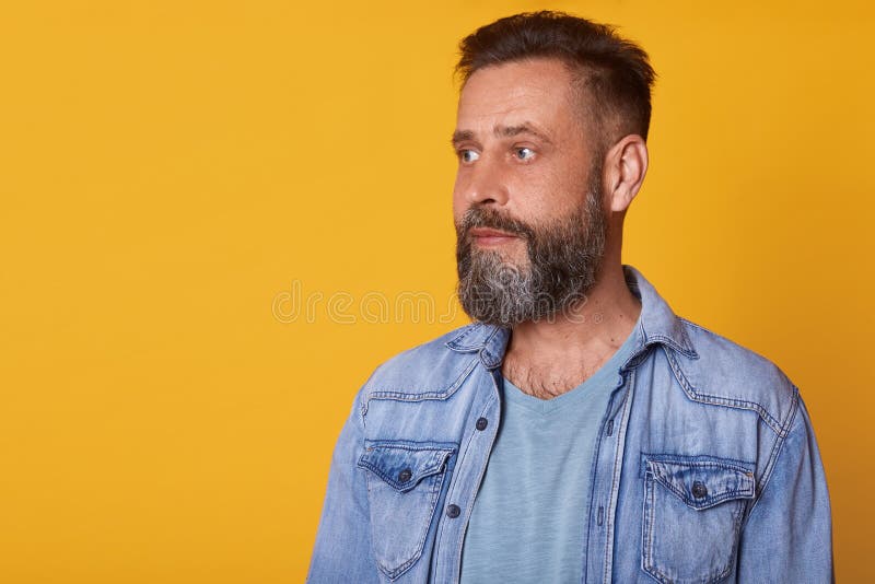 Ritratto alto vicino dell'uomo attento serio che guarda da parte, essendo rivestimento casuale calmo e pensieroso, d'uso dei jean fotografia stock libera da diritti Ritratto alto vicino dell'uomo attento serio che guarda da parte, essendo rivestimento casuale calmo e pensieroso, d'uso dei jean fotografia stock libera da diritti
