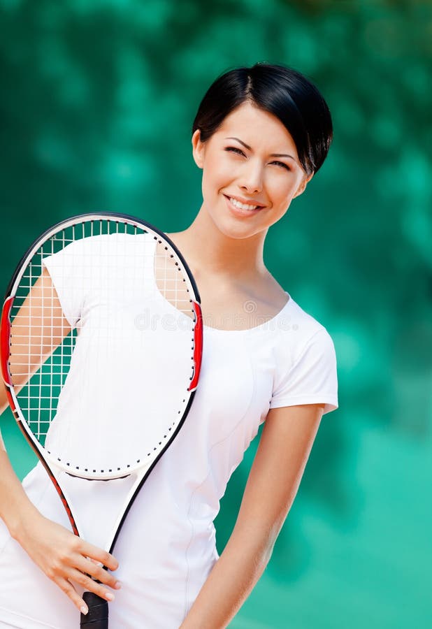 Portrait of professional tennis player with racket at the tennis court. Portrait of professional tennis player with racket at the tennis court