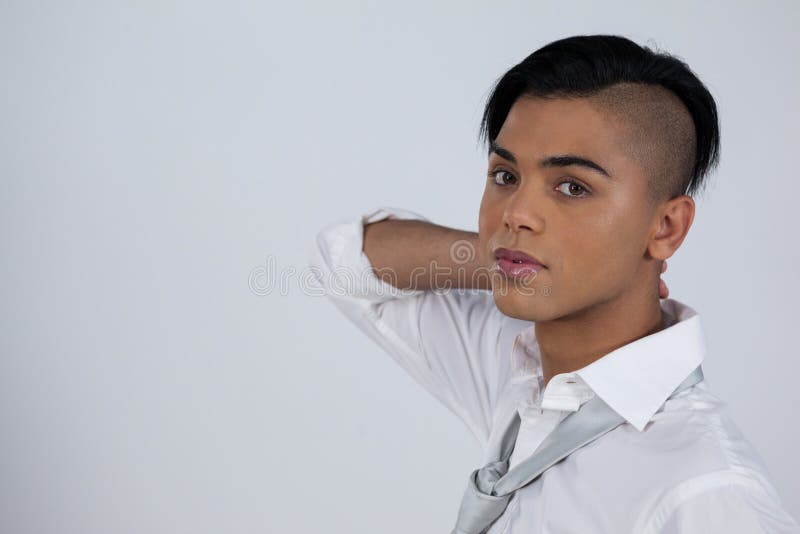 Portrait of transgender woman standing against white background. Portrait of transgender woman standing against white background