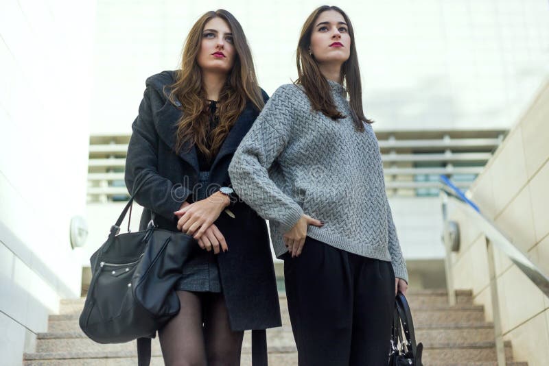 Ritratto di belle giovani donne che posano nella via immagini stock libere da diritti Ritratto di belle giovani donne che posano nella via immagini stock libere da diritti