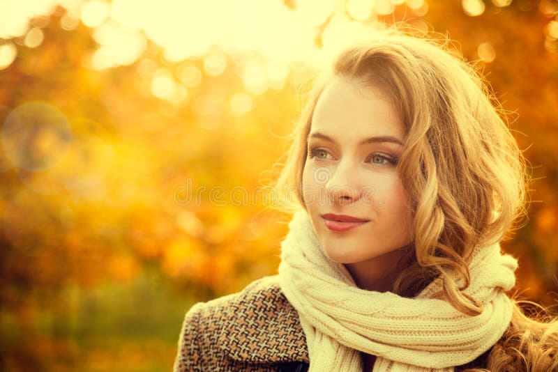 Portrait of Young Fashion Woman Outdoor on Autumn Background. Toned Photo with Bokeh and Copy Space. Portrait of Young Fashion Woman Outdoor on Autumn Background. Toned Photo with Bokeh and Copy Space.