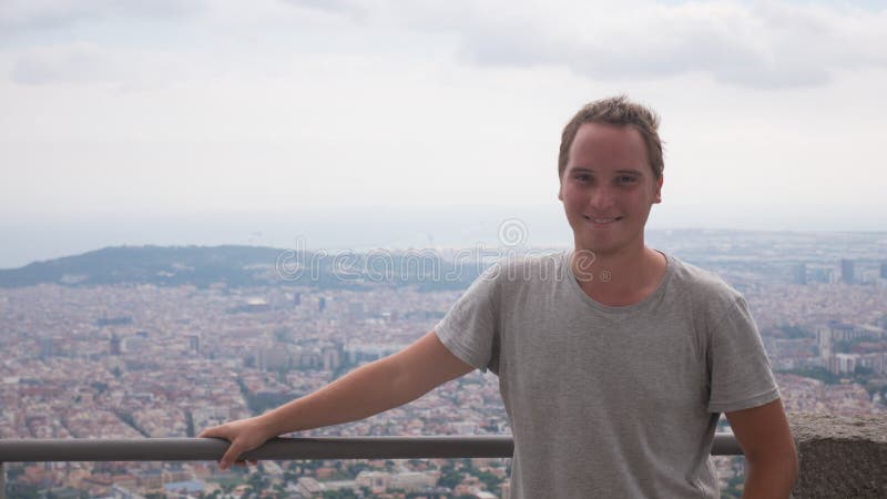 Ritratto di giovane sorridere bello dell'uomo all'aperto - stando sull'alta collina fotografia stock Ritratto di giovane sorridere bello dell'uomo all'aperto - stando sull'alta collina fotografia stock