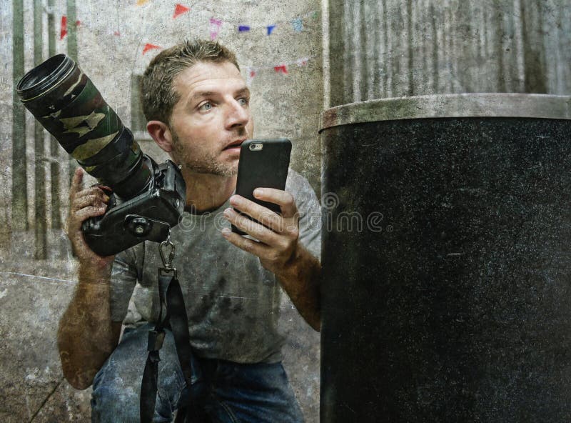 Ritratto divertente di stile di vita di giovane uomo del fotografo dei paparazzi nell'azione nascosto dietro gli appostamenti del fotografia stock libera da diritti Ritratto divertente di stile di vita di giovane uomo del fotografo dei paparazzi nell'azione nascosto dietro gli appostamenti del fotografia stock libera da diritti