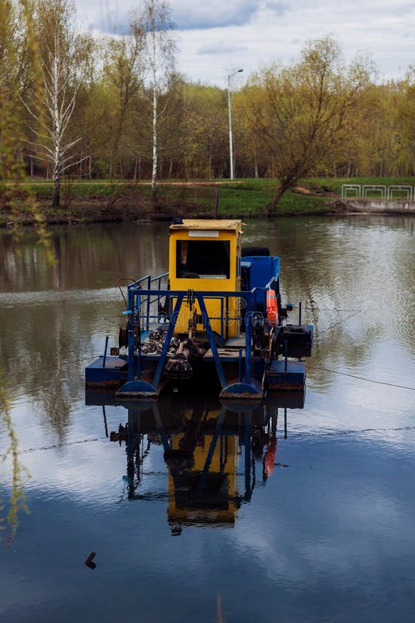 River cleaning boat collects garbage on water stock images