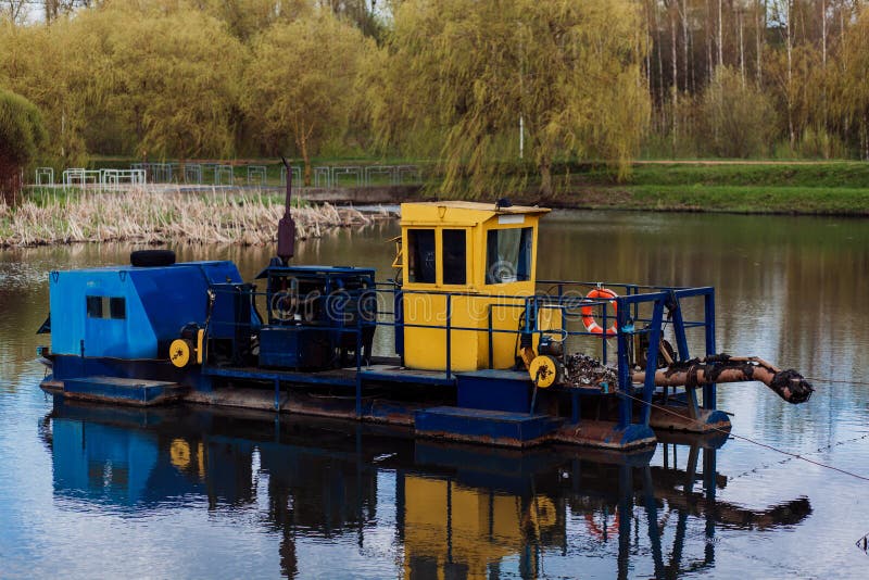 River cleaning boat collects garbage on water. Trash skimmer boat. Floating debris removal systems. Used for removing floating debris from rivers