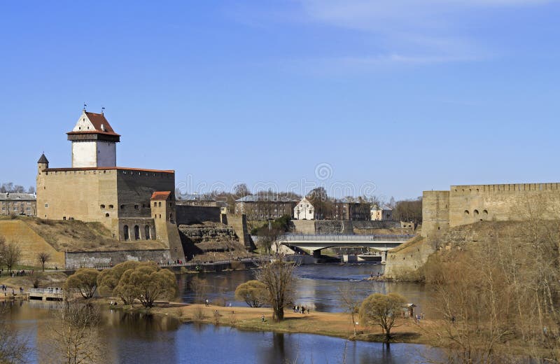 River Narva on border of Russia and Estonia. Narva, Estonia - May 1, 2017: people are walking along riverside Narva river dividing Russia and Estonia stock images River Narva on border of Russia and Estonia. Narva, Estonia - May 1, 2017: people are walking along riverside Narva river dividing Russia and Estonia stock images