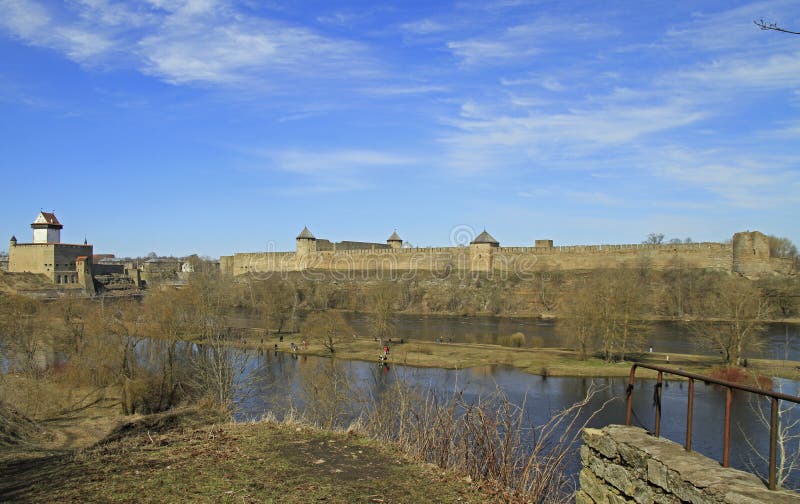 River Narva on border of Russia and Estonia. Narva, Estonia - May 1, 2017: people are walking along riverside Narva river dividing Russia and Estonia royalty free stock photography River Narva on border of Russia and Estonia. Narva, Estonia - May 1, 2017: people are walking along riverside Narva river dividing Russia and Estonia royalty free stock photography