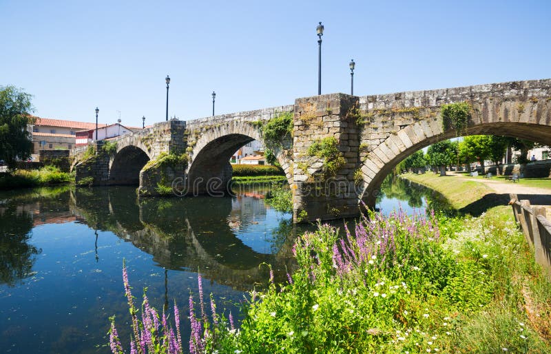 River and old stone bridge at Monforte de Lemos in summer day. Galicia