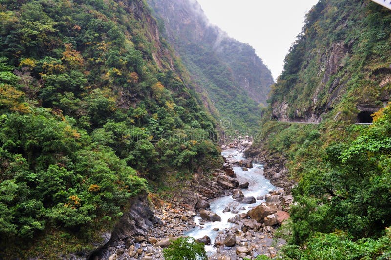 River with rocks at the feet of mountains