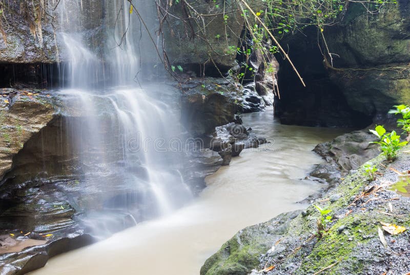 River and waterfall in hidden narrow canyon between mountains, C