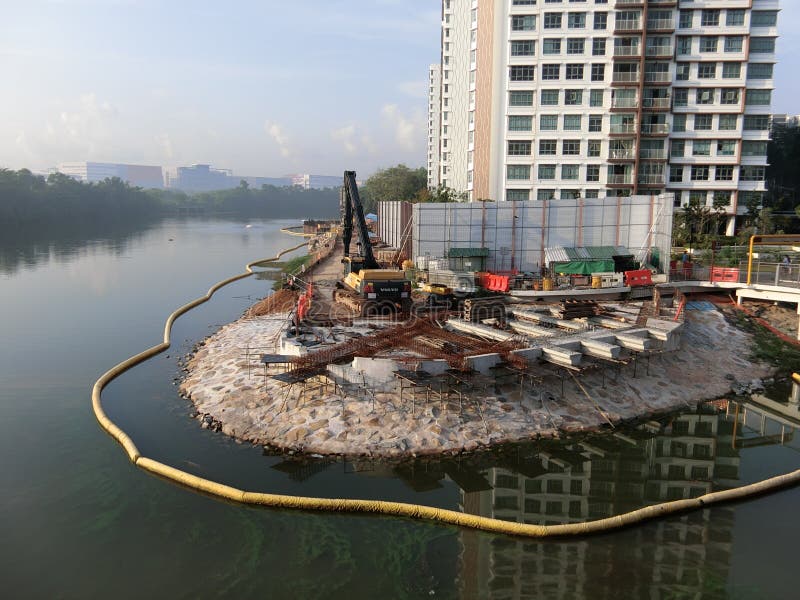 Riverside Construction. May 2017 Image of construction work being carried out along the Serangoon River in Singapore. The river is also known as the Serangoon Riverside Construction. May 2017 Image of construction work being carried out along the Serangoon River in Singapore. The river is also known as the Serangoon