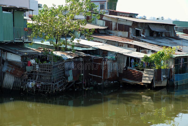 Riverside slum, houses near polluted river