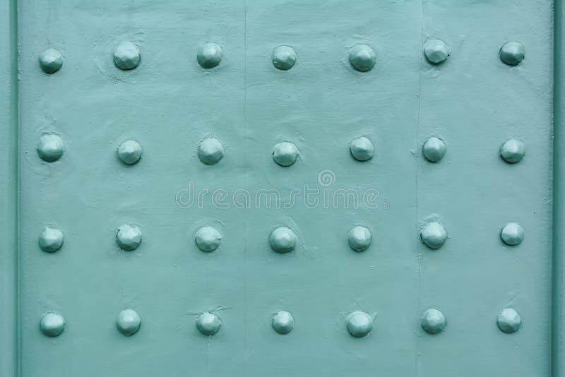 Rivets on a teal painted front door stock photography Rivets on a teal painted front door stock photography