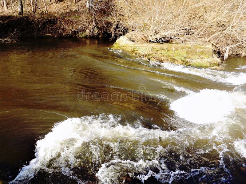 A fast running river in the village of Etal, Northumberland, England. A fast running river in the village of Etal, Northumberland, England.