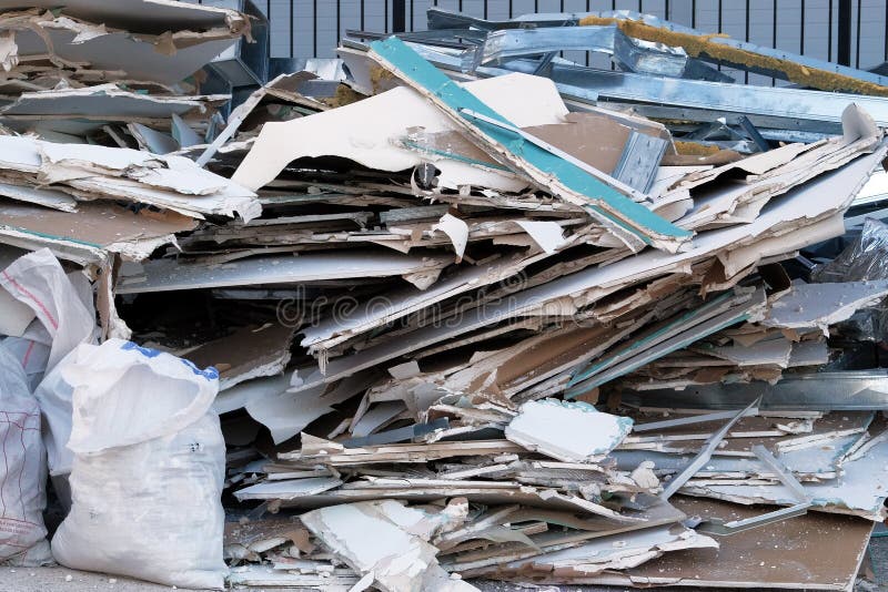 Building demolition. Construction garbage is piled up at site after building repair. Building demolition. Construction garbage is piled up at site after building repair.
