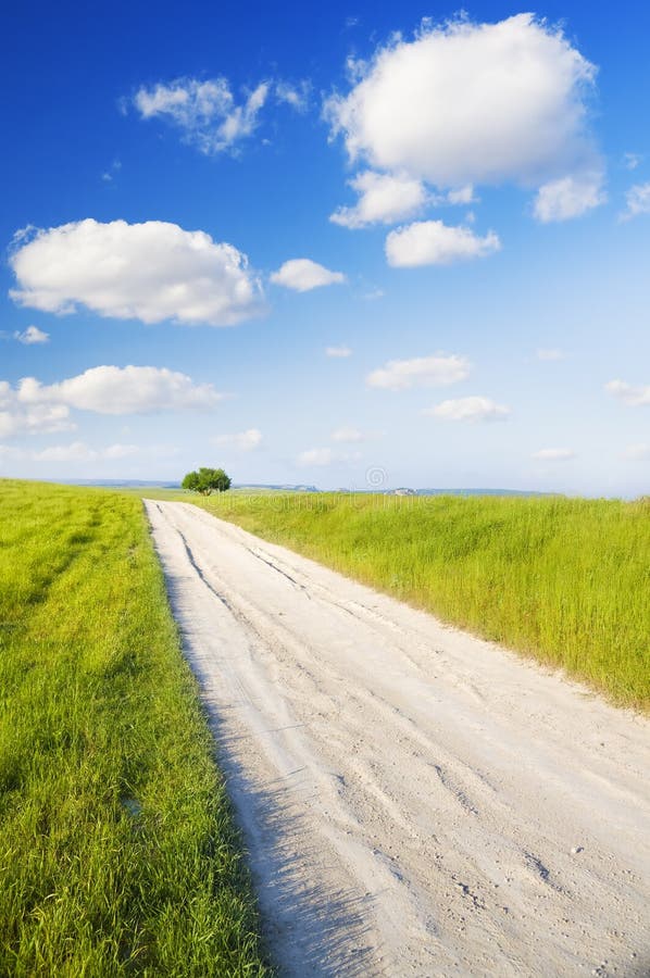 Road amongst green meadow stock photo. Image of outside 25178252