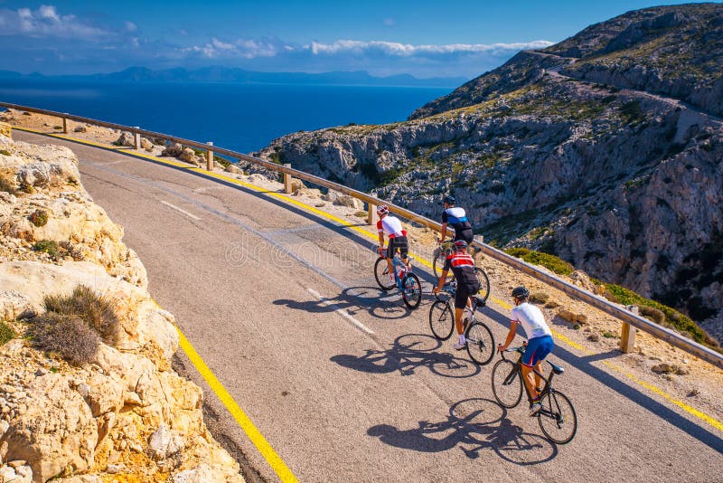 Road bikers on the road on Balearic Islands. Sea in Background. Cap de Formentor. Mallorca, Majorca, Spain