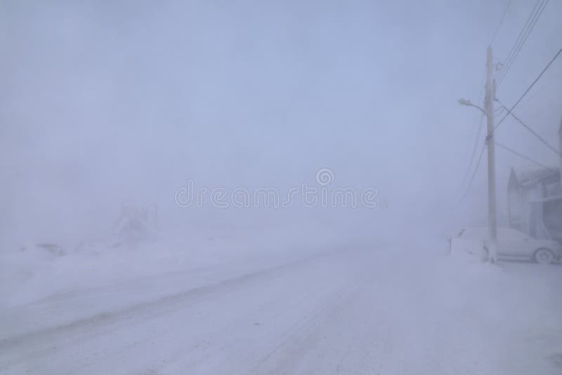 Road and buildings disappearing under blizzard conditions royalty free stock images Road and buildings disappearing under blizzard conditions royalty free stock images