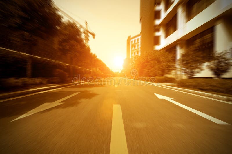 Road in city with sunset stock photography