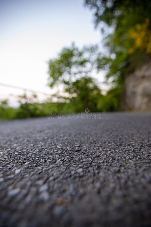 Road from the Ground Level with Green Bokeh Background Stock Photo - Image  of surface, texture: 160114410