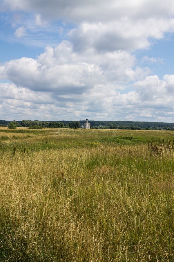 The road leading through the meadow to the Church of the Intercession on the Nerl summer day stock photo The road leading through the meadow to the Church of the Intercession on the Nerl summer day stock photo