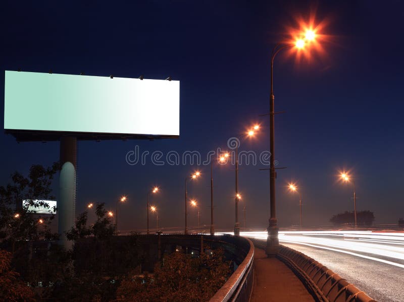 Road with lights and large blank billboard