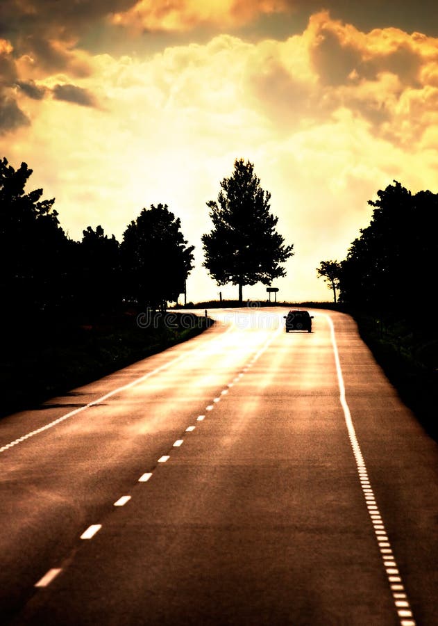 Road with lonely car. Red sunset light and high contrast.