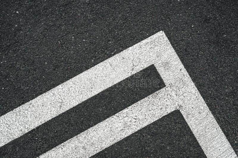 Road marking white lines on asphalt surface as abstract pattern stock photography