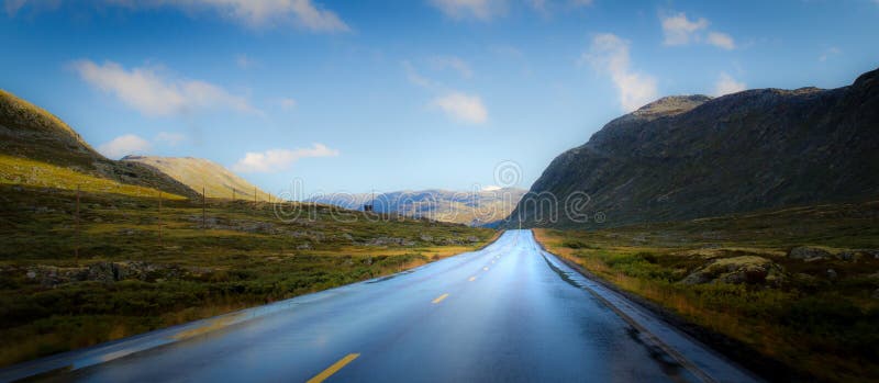 Road into mountain landscape stock images