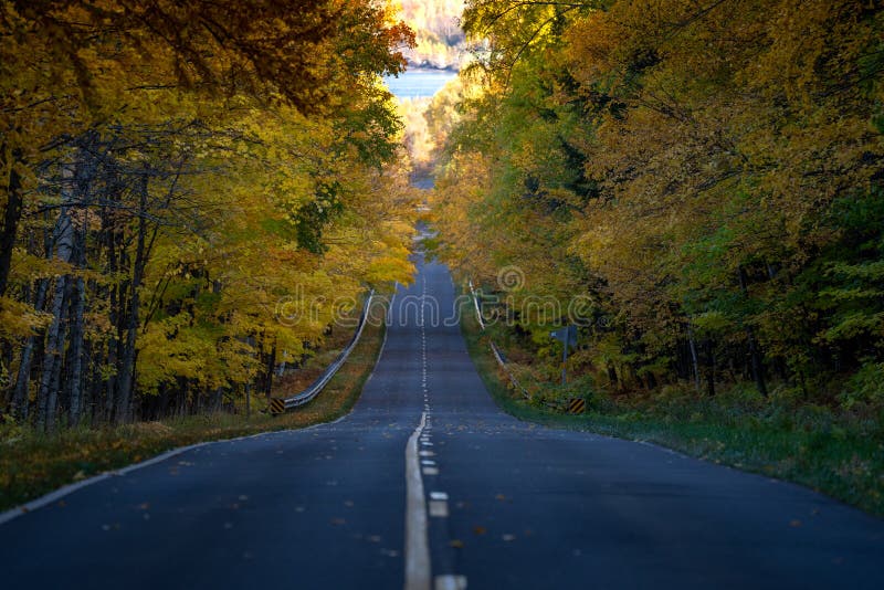 Road through the Porcupine Mountains in the Upper Peninsula in Michigan during the fall. Concept for fall leaf peeping road trip