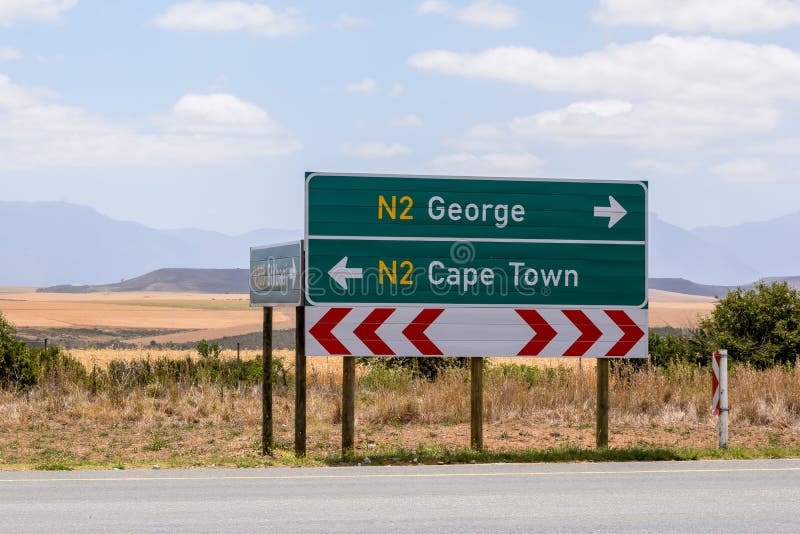 Road sign at the route N2 road in South Africa near Still Bay pointing to Cape Town and George. royalty free stock photos Road sign at the route N2 road in South Africa near Still Bay pointing to Cape Town and George. royalty free stock photos