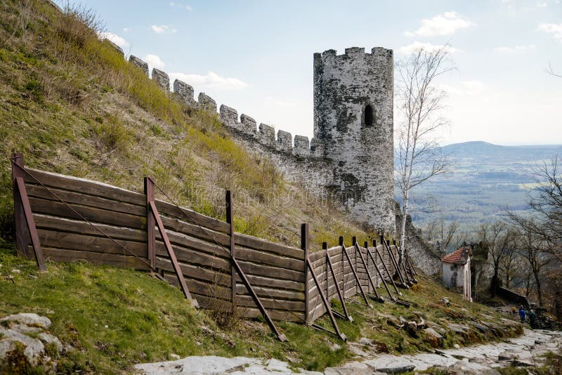 Road to medieval gothic castle Bezdez, grey stone ruin on hill, sunny day, ancient fortress walls, fairytale stronghold, high