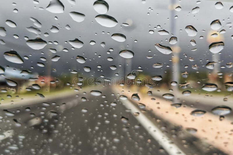 Road View through Car Window Blurry with Heavy Rain, Stock Photo