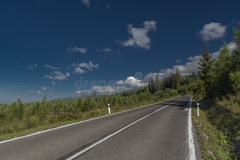 Road in Vysoke Tatry mountains in summer hot sunny day