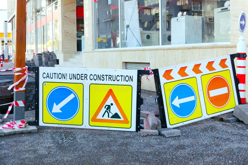Road warning boards signs with inscriptions caution and under construction. stock images Road warning boards signs with inscriptions caution and under construction. stock images