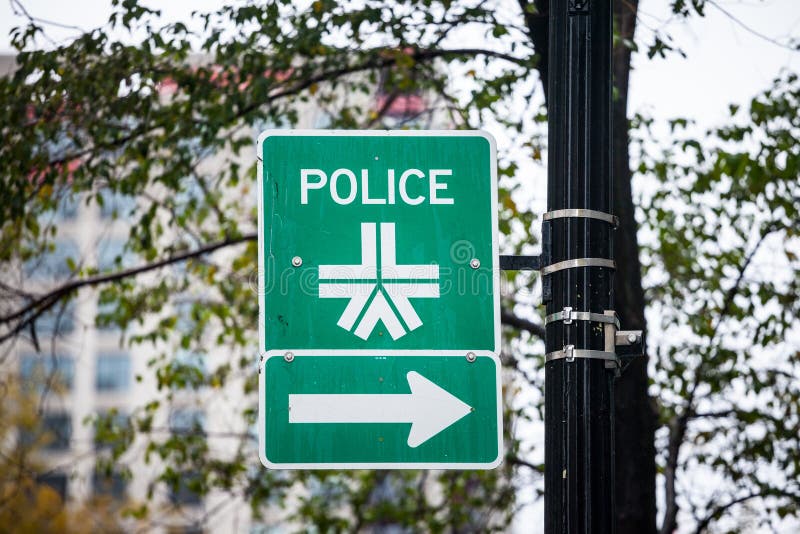 Roadsign indicating the nearest Montreal Police station with its official logo. It is the Police Department of Montreal