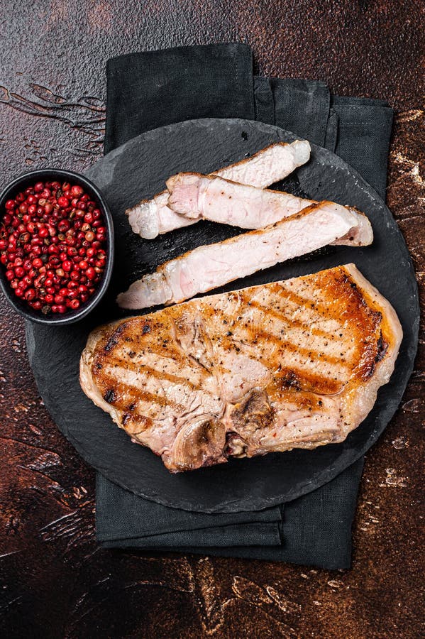 Roast BBQ Pork Chop or T-bone Meat Steak Sliced on a Board. Dark ...