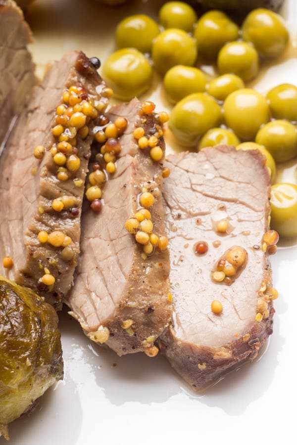 Roast Beef Cut in Slices with Peas on White Dish Stock Image Image of