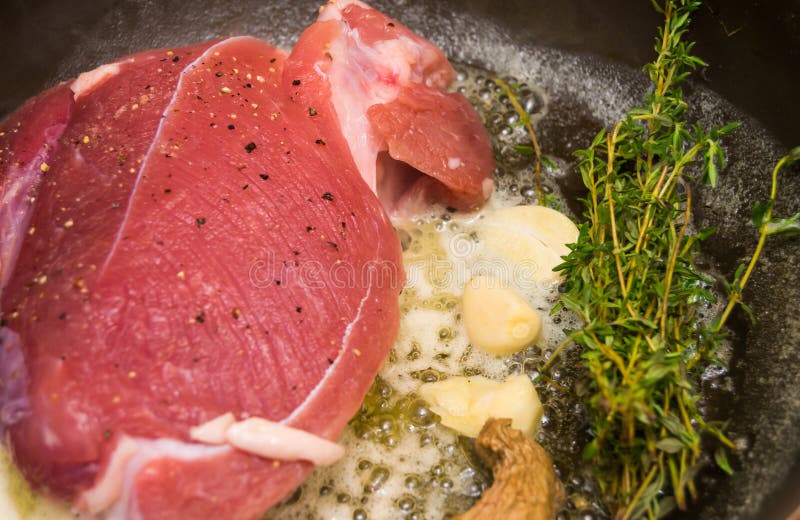 .roast Beef in Pan with Butter, Garlic, Ginger and Thyme Stock Image