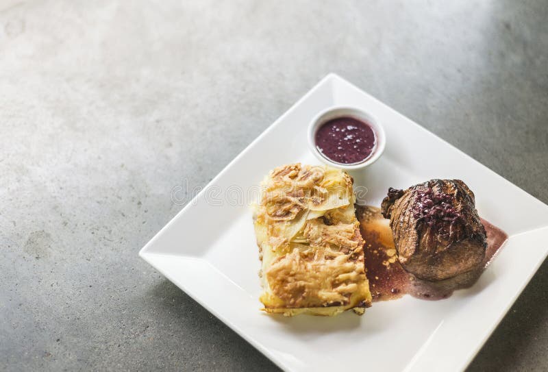 Roast beef with potato cheese bake and beetroot sauce