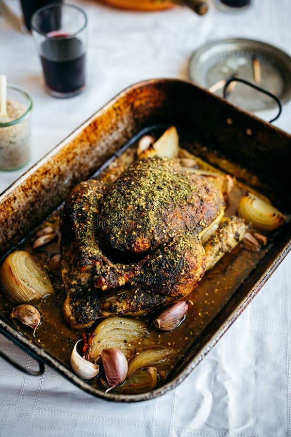 Roast Chicken with Za`atar in vintage roasting tray served on family lunch table. Roasting tray stock images, royalty-free photos and pictures