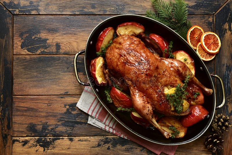 Roast goose stuffed with baked apples in a skillet, festive christmas recipe. Top view with copy space stock photo Roast goose stuffed with baked apples in a skillet, festive christmas recipe. Top view with copy space stock photo
